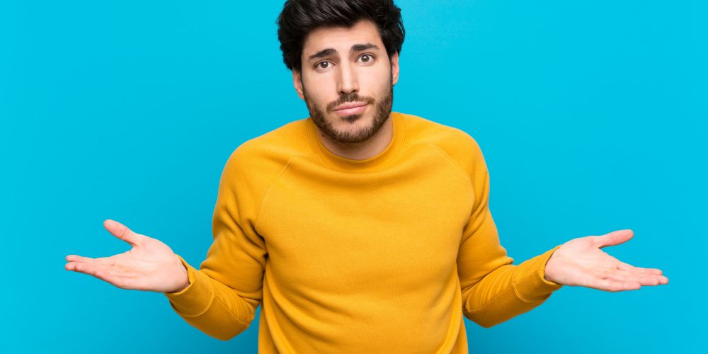 handsome-isolated-blue-wall-having-doubts-while-raising-hands (1) handsome-isolated-blue-wall-having-doubts-while-raising-hands (1)